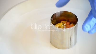 Hands placing professional chef cooking ingredients in a mold