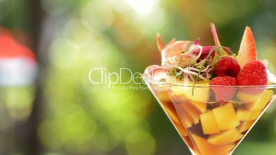 Cocktail cup glass with strawberry, mango and wine