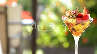 Cocktail cup glass with strawberry, mango and wine