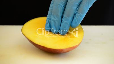 Professional chef hands cutting a mango fruit into slices