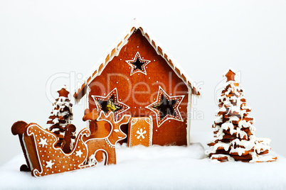 The hand-made eatable gingerbread house and New Year Trees with