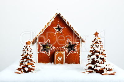The hand-made eatable gingerbread house and New Year Trees with