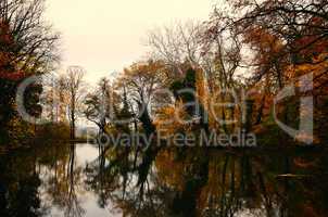 bunter herbstwald mit see und spiegelung