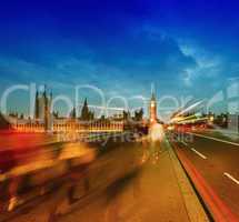 People moving on Westminster Bridge at sunset. Houses of Parliam