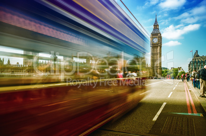 Red Double Decker bus moving on Westminster Bridge with Big Ben