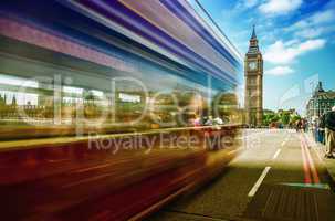 Red Double Decker bus moving on Westminster Bridge with Big Ben