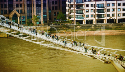 LONDON - SEPTEMBER 27, 2013: Tourists walk on Millennium Bridge.