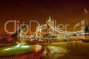 Dolphin Fountain and Tower Bridge at night, London