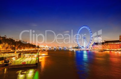 London night skyline along river Thames. Panoramic wheel, buildi