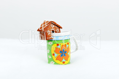 The hand-made eatable gingerbread houses on a cup and snow decor