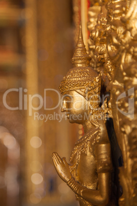 gold buddha statue on the wall in church at buddhist temple in T