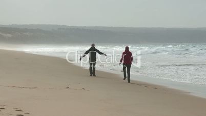 Happy Middle-aged Couple Walking on Ocean Sandy Beach