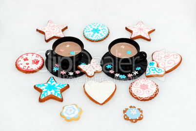 The hand-made eatable gingerbread cookies near cups with cocoa a