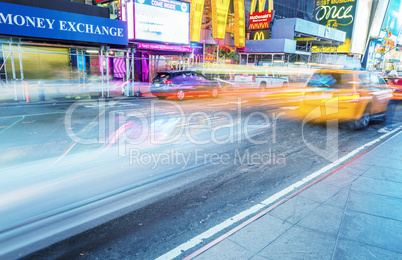 NEW YORK CITY - JUNE 11, 2013: Taxi cabs speed up along city str