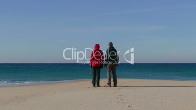 Happy Middle-aged Couple Walking on Ocean Sandy Beach