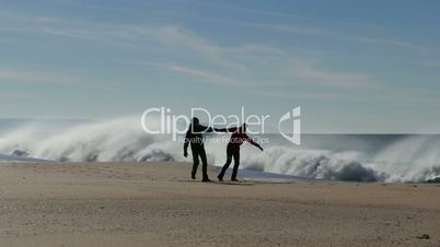 Happy Middle-aged Couple Walking on Ocean Sandy Beach