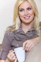 Beautiful Blond Woman Drinking Tea or Coffee At Home