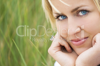 Woman With Blond Hair Blue Eyes Green Background