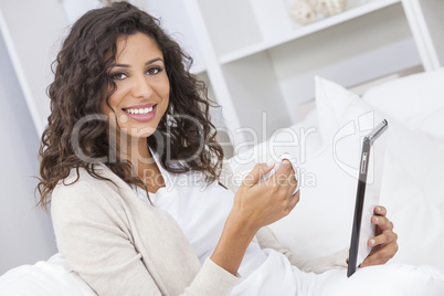 Woman Drinking Tea or Coffee Using Tablet Computer