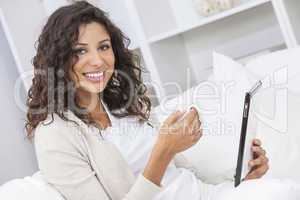 Woman Drinking Tea or Coffee Using Tablet Computer