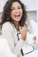 Woman Drinking Tea or Coffee Using Tablet Computer