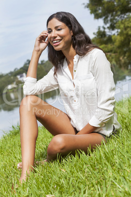 Latina Woman Girl Sitting On Grass by Lake in Summer