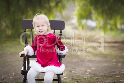 Adorable Little Girl Sitting in Her Chair Outside