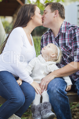 Happy Pregnant Couple Kisses as Baby Girl Watches