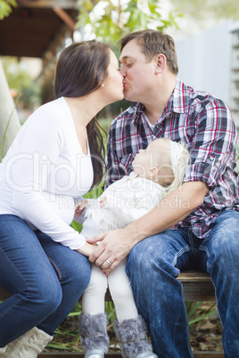Happy Pregnant Couple Kisses as Baby Girl Watches