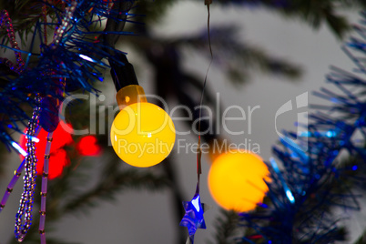 Bright garland on a Christmas tree abstract festive background