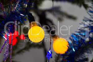 Bright garland on a Christmas tree abstract festive background