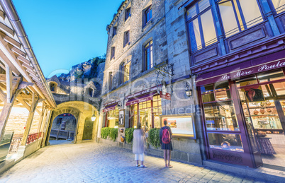 MONT SAINT-MICHEL, FRANCE - JUNE 12, 2014: Tourists walk along c