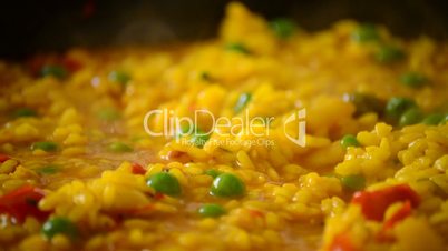 Paella rice boiling close up