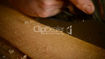 Carpenter or luthier sanding or polish wood with a wood planer