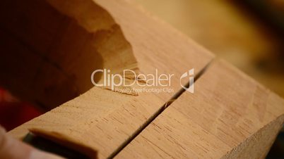 Luthier with chisel working in wood, close up