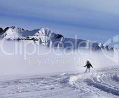 Snowboarder downhill on off-piste slope with newly fallen snow