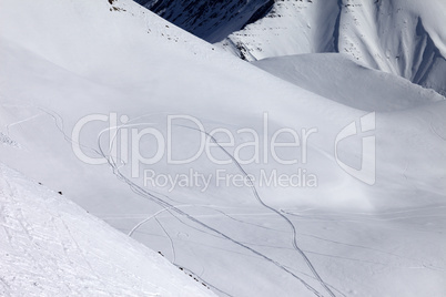 View on snowy off piste slope with trace from ski and snowboards