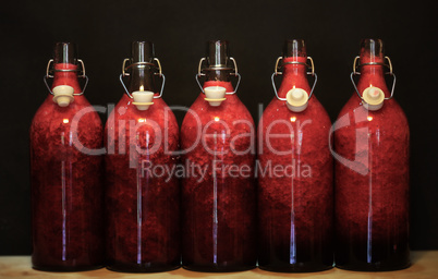 Red liquid in glasses isolated on black background