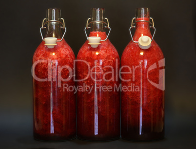 Red liquid in glasses isolated on black background