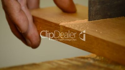 Luthier, carpenter, craftsman, cutting wood with hacksaw