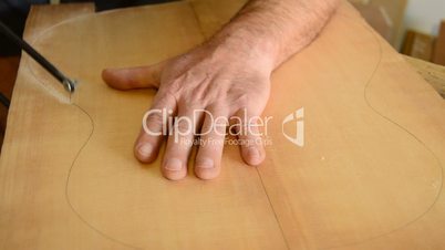 Cutting wood with hacksaw for a flamenco guitar