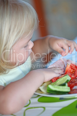 Portrait of sweet little girl having lunch