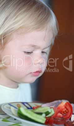 Portrait of sweet little girl having lunch