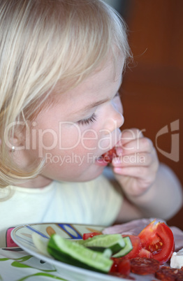 Portrait of sweet little girl having lunch