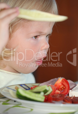 Portrait of sweet little girl having lunch