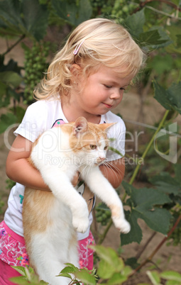 Cute little girl holding a red cat