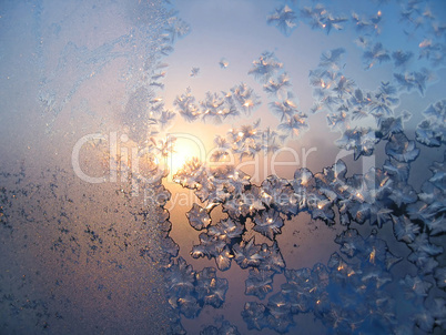 Ice pattern and sunlight on winter glass