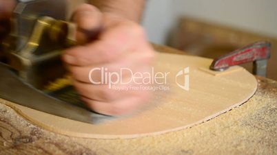 Luthier polishes wood for flamenco guitar