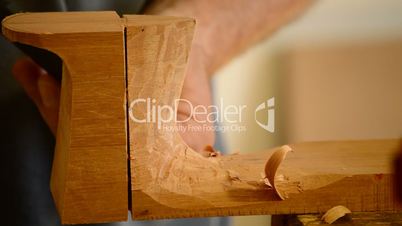 Luthier with chisel working in wood