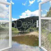 window opened to the river and mountains